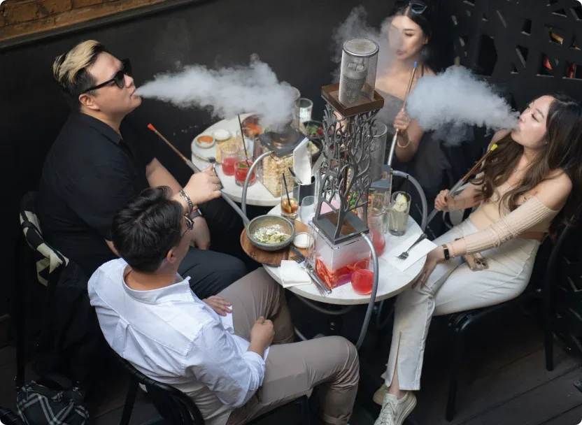 Guests enjoying shisha and cocktails on the terrace at Laika Shisha Lounge in Soho