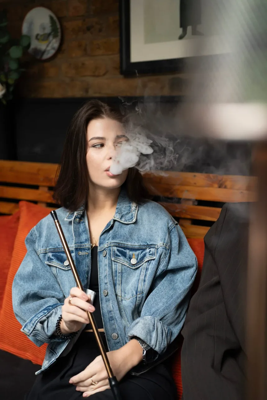 Guest enjoying shisha in an orange booth at Laika Shisha Lounge in Soho