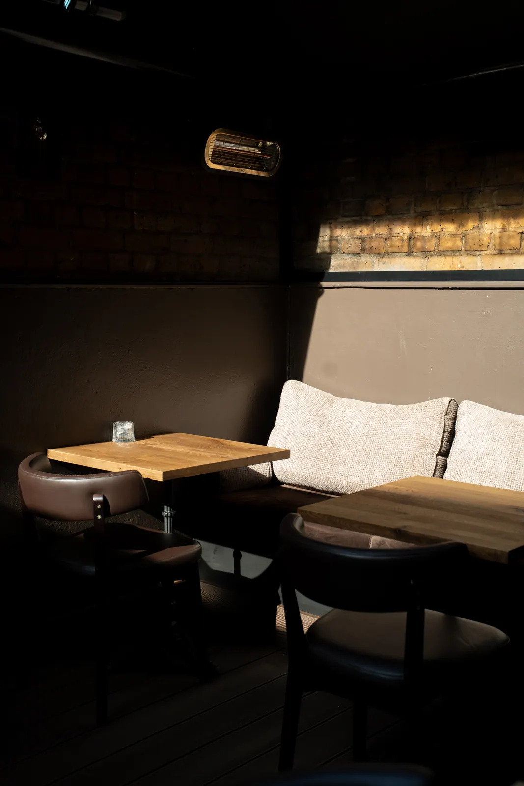 Warm light on new tables and chairs at Laika